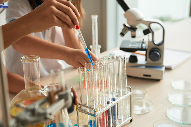 Children working with chemicals at science class