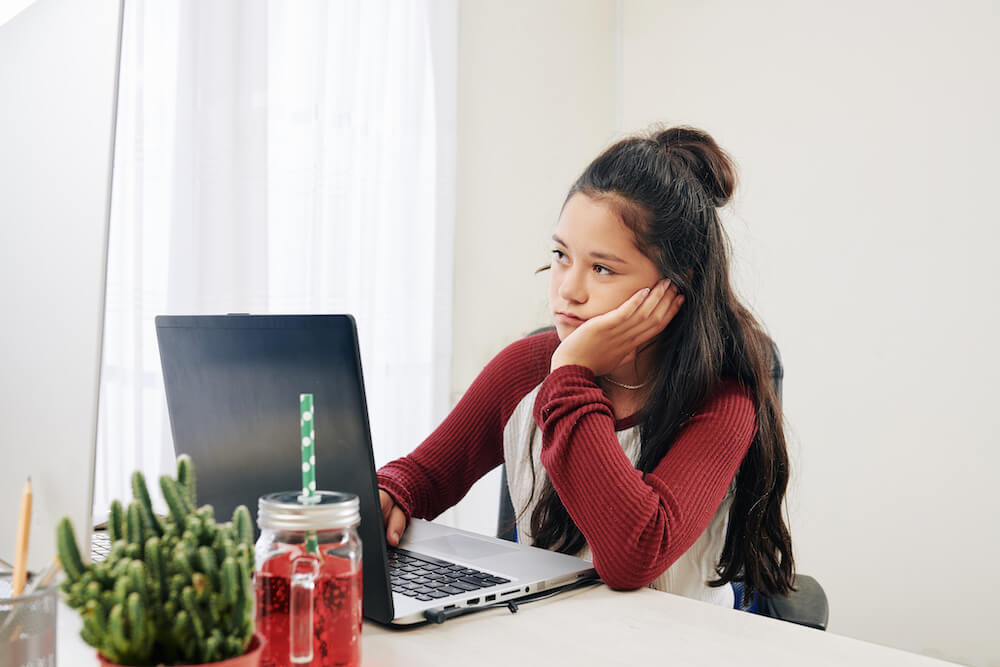 Student looking at the computer waiting to get their decision from college. | Command Education