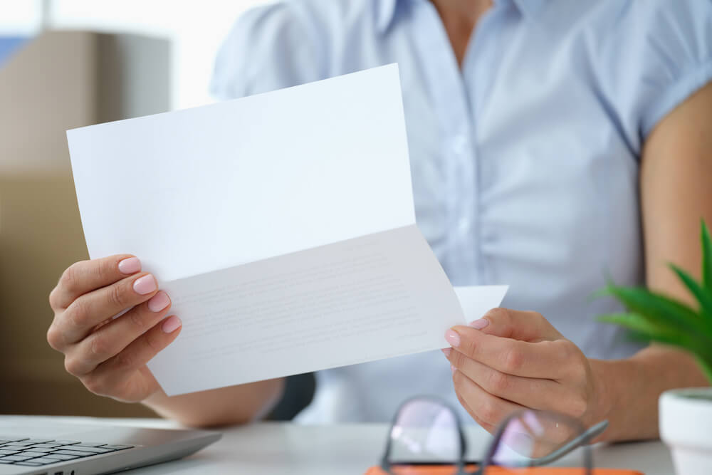 Student reading a letter for the decision on their college application | Command Education