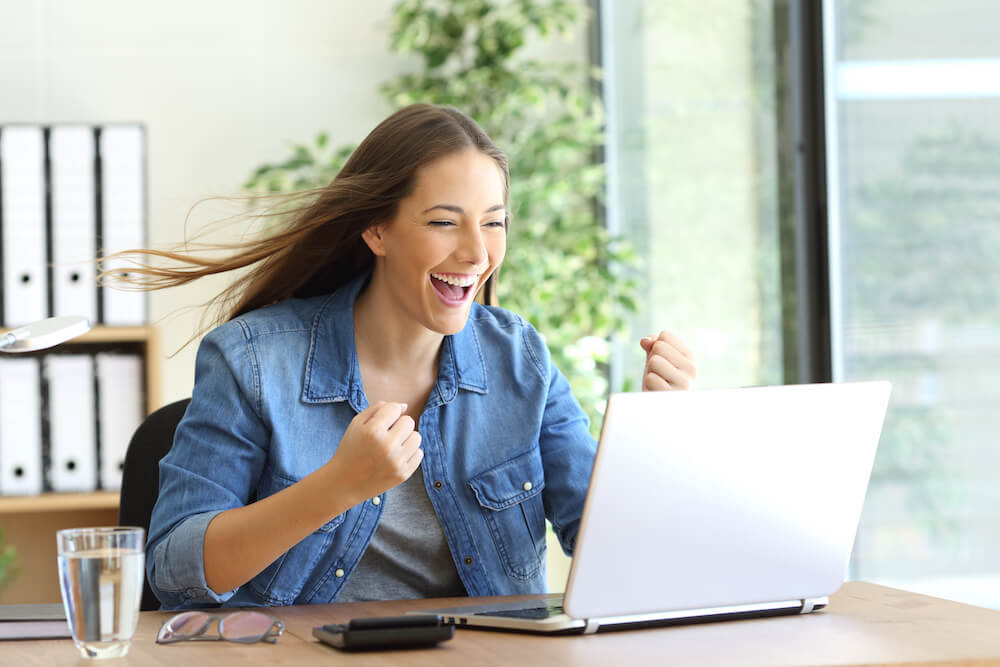 Student sitting at laptop reading their results for Early Decision for a college or university | Command Education